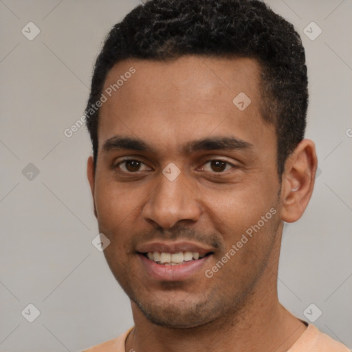 Joyful black young-adult male with short  black hair and brown eyes