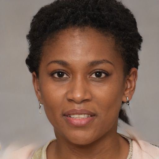 Joyful black young-adult female with short  brown hair and brown eyes