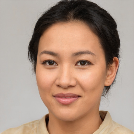 Joyful asian young-adult female with medium  brown hair and brown eyes