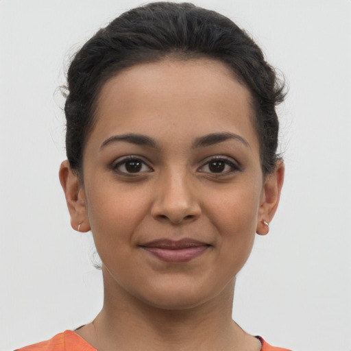 Joyful latino young-adult female with short  brown hair and brown eyes