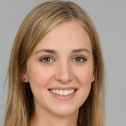 Joyful white young-adult female with long  brown hair and green eyes