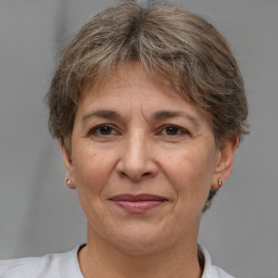 Joyful white middle-aged female with short  brown hair and brown eyes