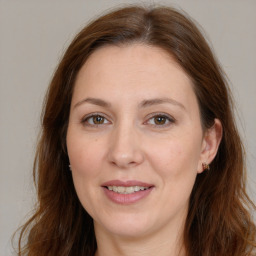 Joyful white adult female with long  brown hair and brown eyes