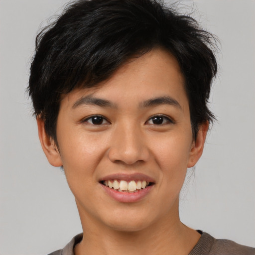 Joyful asian young-adult female with short  black hair and brown eyes
