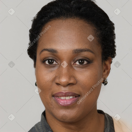 Joyful black adult female with short  brown hair and brown eyes