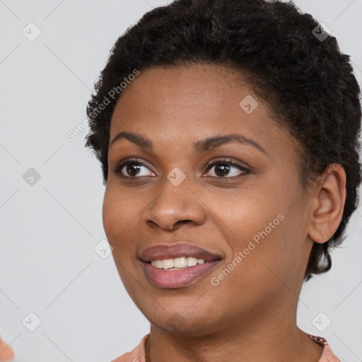 Joyful black young-adult female with short  brown hair and brown eyes