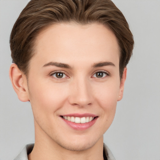 Joyful white young-adult female with short  brown hair and brown eyes