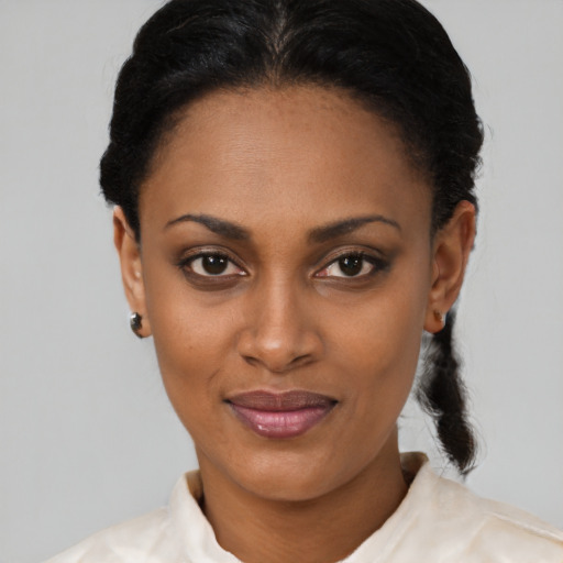Joyful latino young-adult female with short  black hair and brown eyes