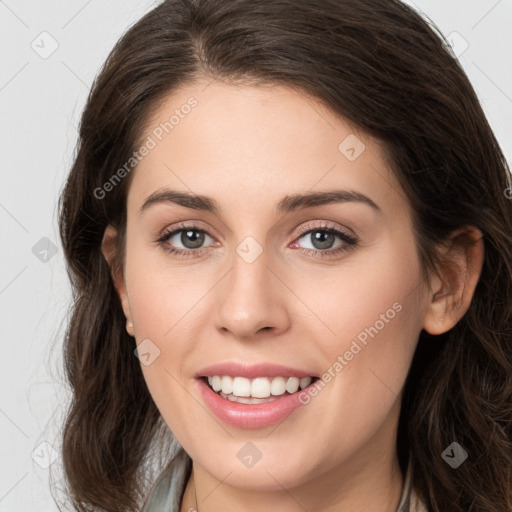 Joyful white young-adult female with long  brown hair and grey eyes