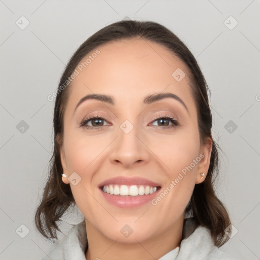 Joyful white young-adult female with medium  brown hair and brown eyes