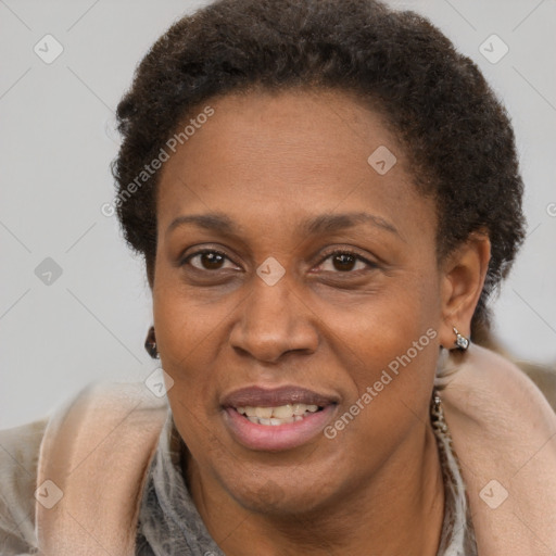 Joyful black adult female with short  brown hair and brown eyes