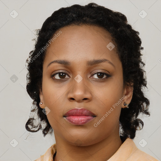 Joyful black young-adult female with long  black hair and brown eyes