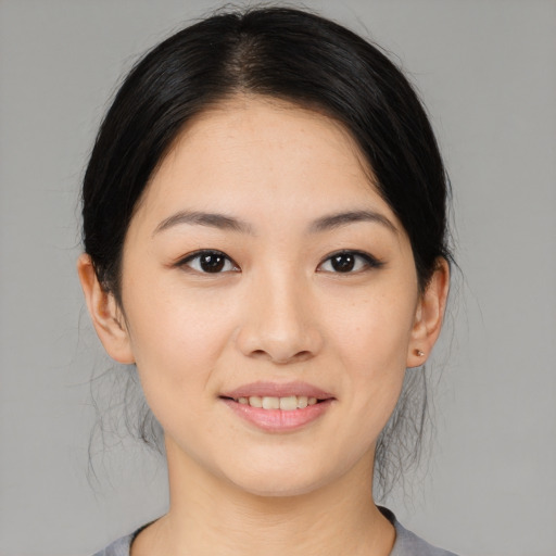 Joyful asian young-adult female with medium  black hair and brown eyes