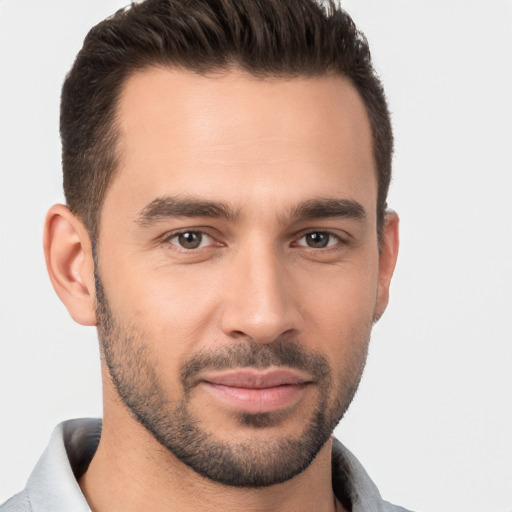 Joyful white young-adult male with short  brown hair and brown eyes