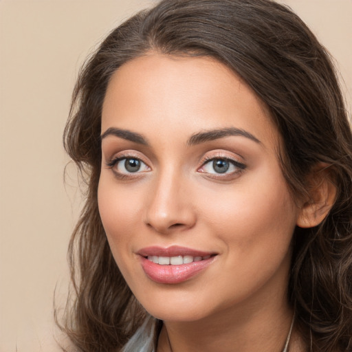 Joyful white young-adult female with long  brown hair and brown eyes