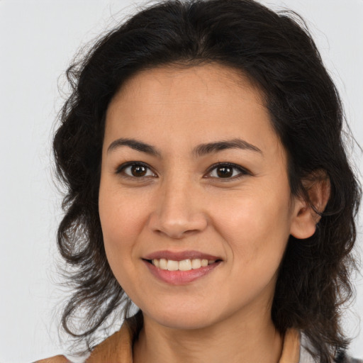 Joyful latino young-adult female with medium  brown hair and brown eyes