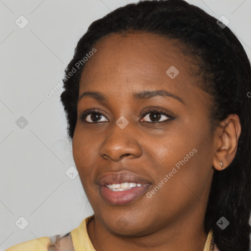 Joyful black young-adult female with long  black hair and brown eyes