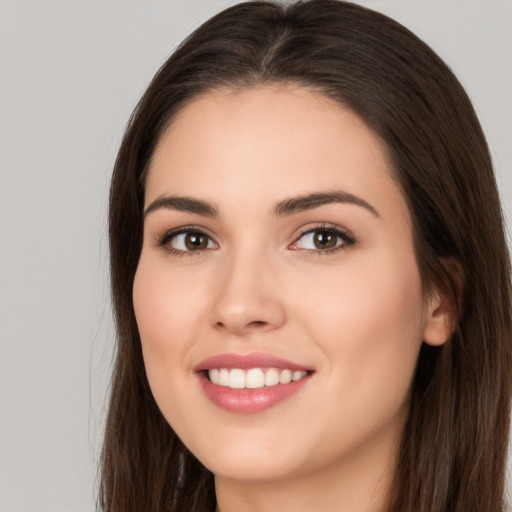 Joyful white young-adult female with long  brown hair and brown eyes