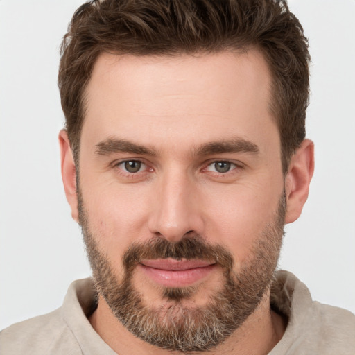 Joyful white young-adult male with short  brown hair and brown eyes