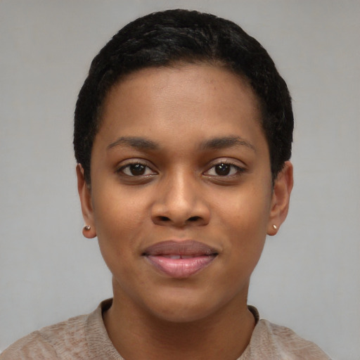 Joyful black young-adult female with short  black hair and brown eyes