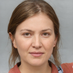 Joyful white adult female with medium  brown hair and grey eyes