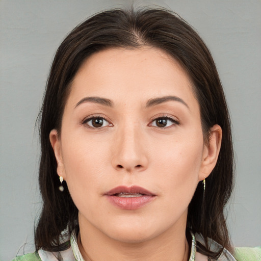 Joyful white young-adult female with medium  brown hair and brown eyes