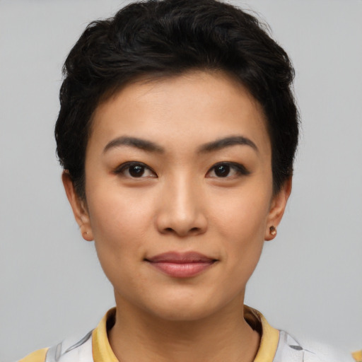 Joyful asian young-adult female with short  brown hair and brown eyes