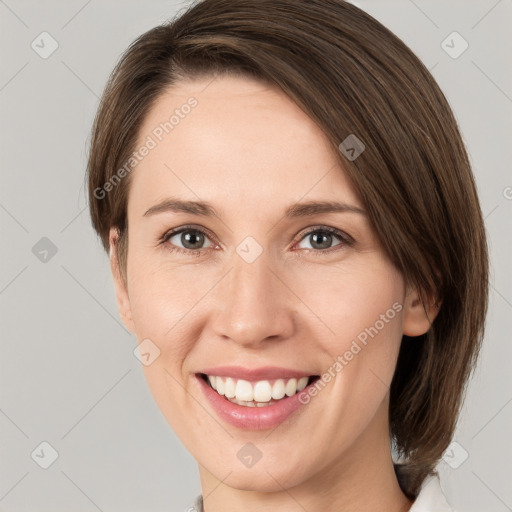 Joyful white young-adult female with medium  brown hair and grey eyes