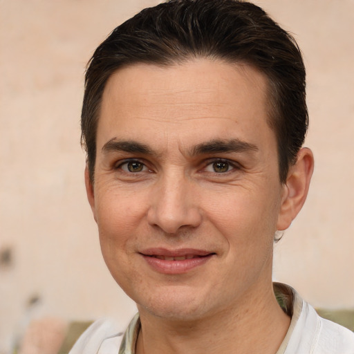 Joyful white adult male with short  brown hair and brown eyes