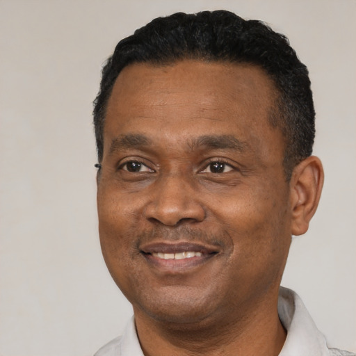 Joyful black adult male with short  black hair and brown eyes