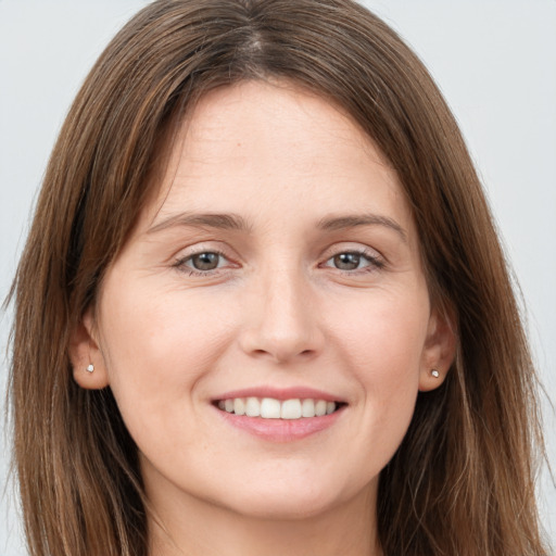 Joyful white young-adult female with long  brown hair and grey eyes