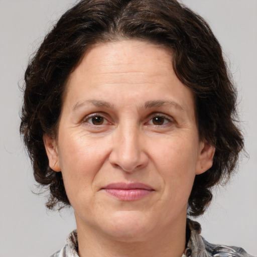 Joyful white adult female with medium  brown hair and brown eyes