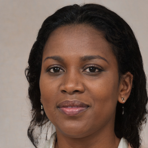 Joyful black young-adult female with medium  black hair and brown eyes