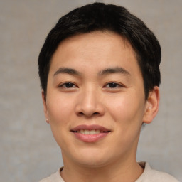 Joyful asian young-adult male with short  brown hair and brown eyes