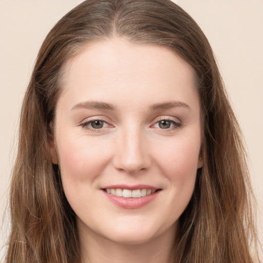 Joyful white young-adult female with long  brown hair and grey eyes