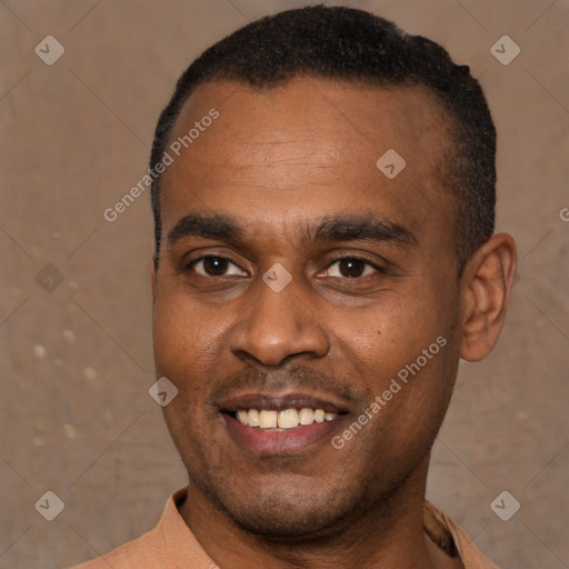 Joyful black young-adult male with short  black hair and brown eyes