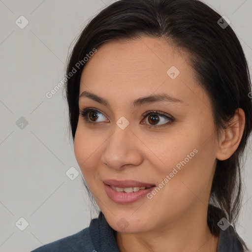 Joyful asian young-adult female with medium  brown hair and brown eyes