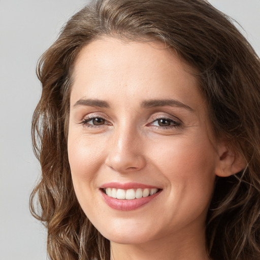 Joyful white young-adult female with long  brown hair and grey eyes