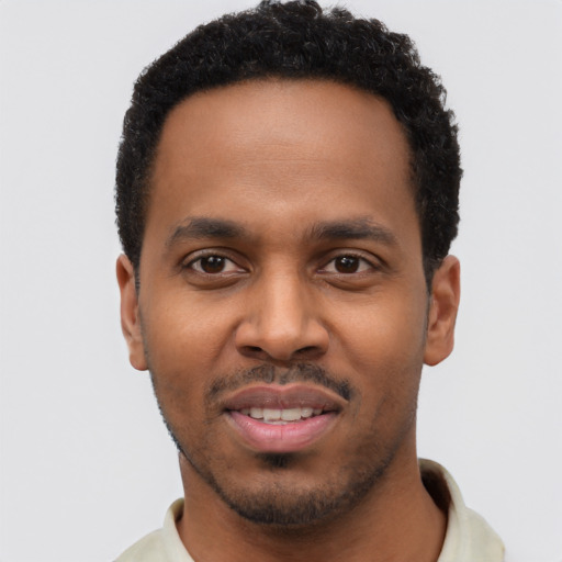 Joyful black young-adult male with short  black hair and brown eyes