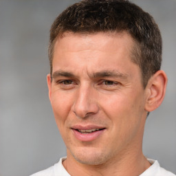 Joyful white adult male with short  brown hair and brown eyes