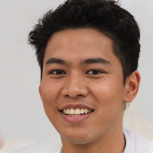 Joyful asian young-adult male with short  brown hair and brown eyes
