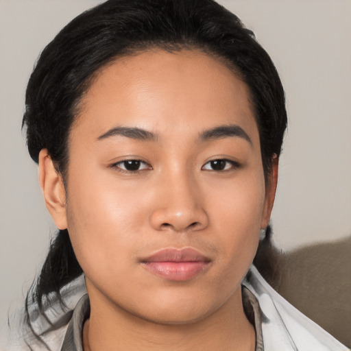 Joyful latino young-adult female with medium  brown hair and brown eyes