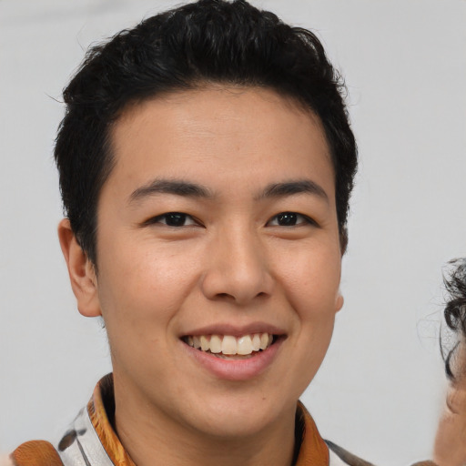 Joyful black young-adult male with short  brown hair and brown eyes