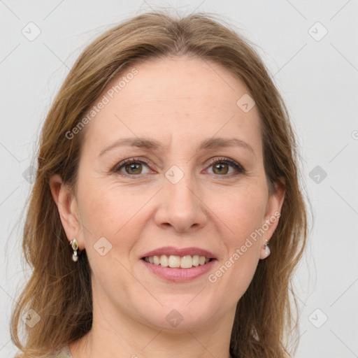 Joyful white adult female with long  brown hair and grey eyes