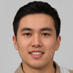 Joyful asian young-adult male with short  brown hair and brown eyes