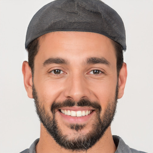 Joyful white young-adult male with short  black hair and brown eyes