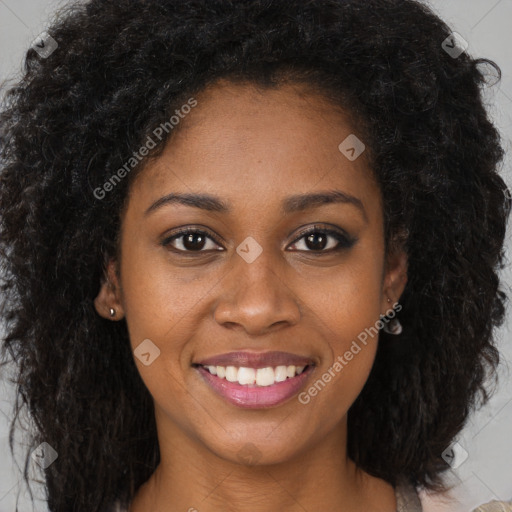 Joyful black young-adult female with long  brown hair and brown eyes