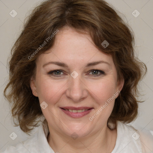 Joyful white adult female with medium  brown hair and grey eyes