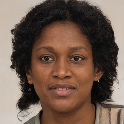 Joyful black young-adult female with medium  brown hair and brown eyes