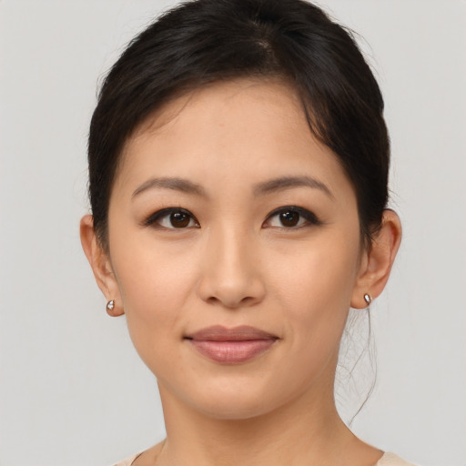 Joyful asian young-adult female with short  brown hair and brown eyes